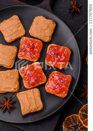 Delicious nutritious sandwiches with peanut butter, strawberry jam Delicious nutritious sandwiches with peanut butter, strawberry jam 111707809