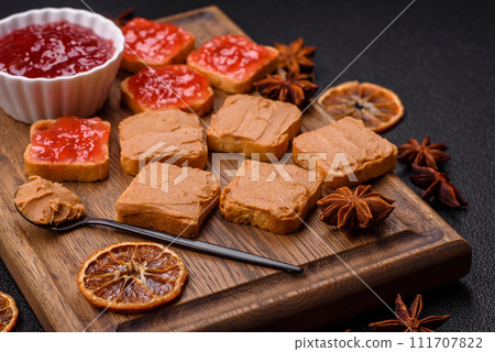 Delicious nutritious sandwiches with peanut butter, strawberry jam Delicious nutritious sandwiches with peanut butter, strawberry jam 111707822