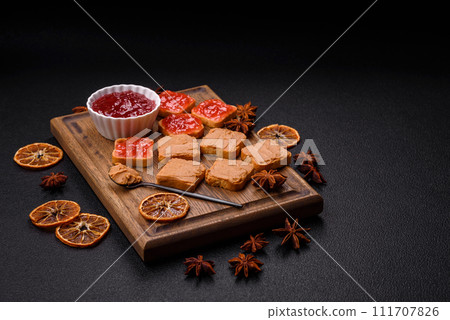 Delicious nutritious sandwiches with peanut butter, strawberry jam Delicious nutritious sandwiches with peanut butter, strawberry jam 111707826