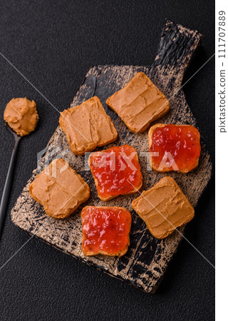 Delicious nutritious sandwiches with peanut butter, strawberry jam Delicious nutritious sandwiches with peanut butter, strawberry jam 111707889