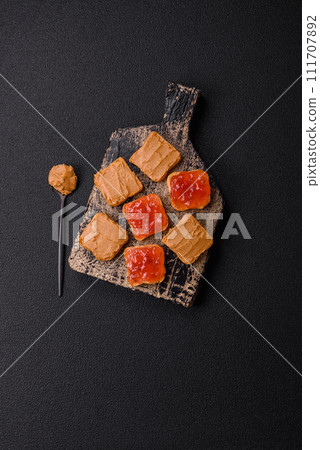 Delicious nutritious sandwiches with peanut butter, strawberry jam Delicious nutritious sandwiches with peanut butter, strawberry jam 111707892