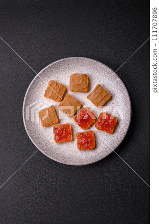 Delicious nutritious sandwiches with peanut butter, strawberry jam 111707896