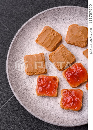 Delicious nutritious sandwiches with peanut butter, strawberry jam Delicious nutritious sandwiches with peanut butter, strawberry jam 111707900