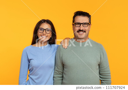 European retired glad woman and man with glasses, standing shoulder to shoulder European retired glad woman and man with glasses, standing shoulder to shoulder 111707924