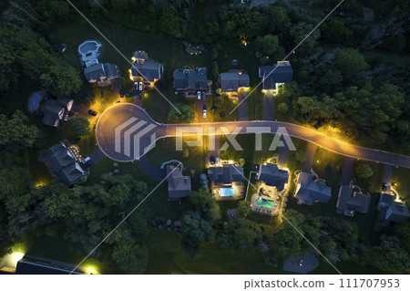 View from above of residential houses in living area in Rochester, NY at night. Illuminated american dream homes as example of real estate development in US suburbs 111707953