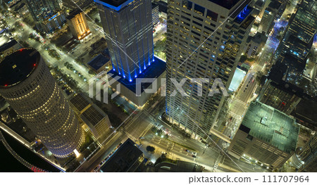 View from above of brightly illuminated high skyscraper buildings and street traffic in downtown district of Tampa city in Florida, USA. American megapolis with business financial district at night 111707964