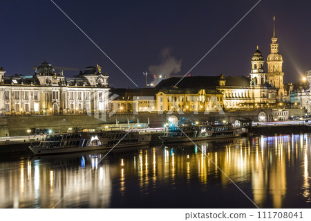Night cityscape view of historic buildings with reflections in Elbe river in the center of Dresden (Germany). 111708041
