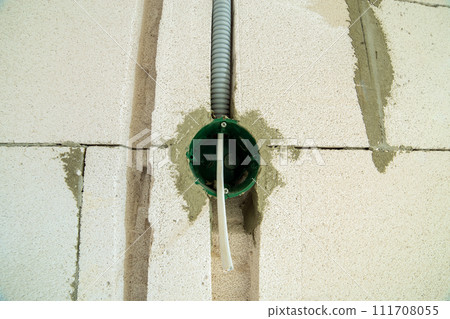 New electrical wiring installation, plastic boxe and electrical cable for future outlet sockets on the wall, renovation concept. 111708055