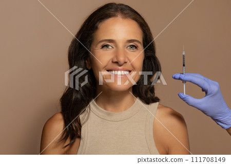 Glad caucasian old lady, enjoy anti-wrinkle treatment, beautician makes injection Glad caucasian old lady, enjoy anti-wrinkle treatment, beautician makes injection 111708149