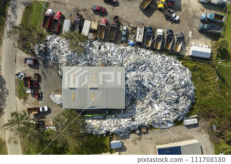 Beg pile of scrap aluminum metal siding from ruined houses after hurricane Ian swept through Florida. Recycle of broken parts of mobile homes Beg pile of scrap aluminum metal siding from ruined houses after hurricane Ian swept through Florida. Recycle of broken parts of mobile homes 111708180