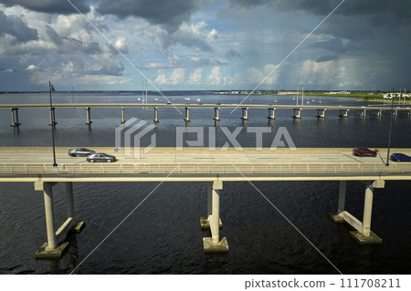 Barron Collier Bridge and Gilchrist Bridge in Florida with moving traffic. Transportation infrastructure in Charlotte County connecting Punta Gorda and Port Charlotte over Peace River 111708211