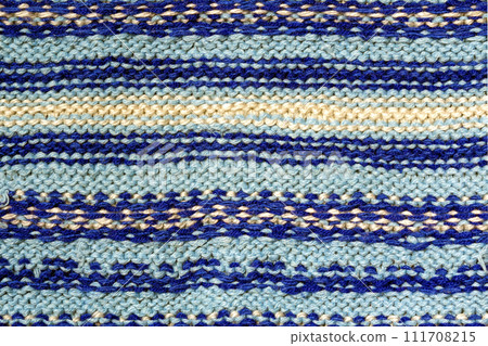 Background texture of blue pattern knitted fabric made of cotton or wool closeup Background texture of blue pattern knitted fabric made of cotton or wool closeup 111708215