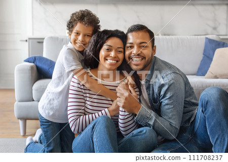 Happy Loving Family. Cheerful African American parents and son posing for photo at home Happy Loving Family. Cheerful African American parents and son posing for photo at home 111708237