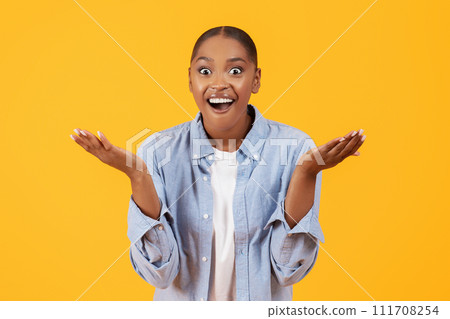 Portrait of young black woman shouting OMG feeling excited, studio 111708254