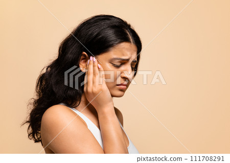 Headache Concept. Portrait of stressed young indian woman suffering from migraine Headache Concept. Portrait of stressed young indian woman suffering from migraine 111708291