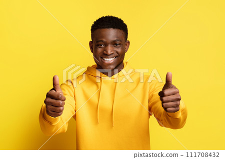 Positive cool young african american guy showing thumbs up 111708432