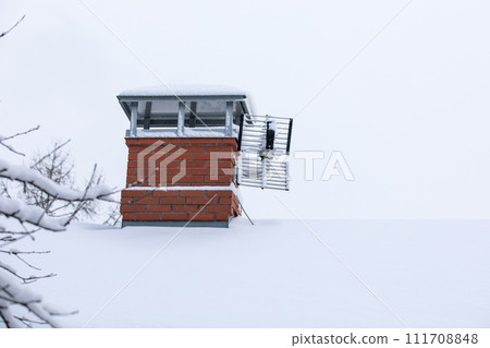 Chimney of a private house. Heating season, winter 111708848