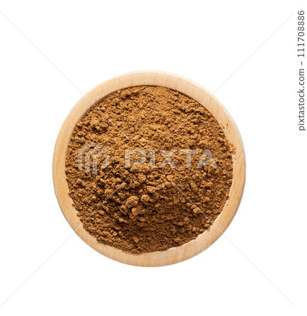 cinnamon powder in a wooden bowl isolated on a white background, top view. cinnamon powder in a wooden bowl isolated on a white background, top view. 111708886