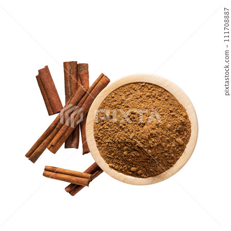 cinnamon sticks and wooden bowl with cinnamon powder isolated on a white background, top view. cinnamon sticks and wooden bowl with cinnamon powder isolated on a white background, top view. 111708887