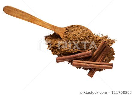 cinnamon powder in a wooden scoop and cinnamon sticks isolated on a white background ,top view. 111708893