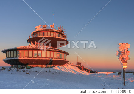 Winter, sunrise time,  disc shaped meteorological observatory in snezka, mountain on the border between Czech Republic and Poland. 111708968