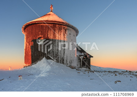 Winter, sunrise time, wooden Roman catholic chapel  in snezka, mountain on the border between Czech Republic and Poland. 111708969