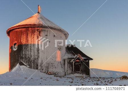 Winter, sunrise time, wooden Roman catholic chapel  in snezka, mountain on the border between Czech Republic and Poland. 111708971