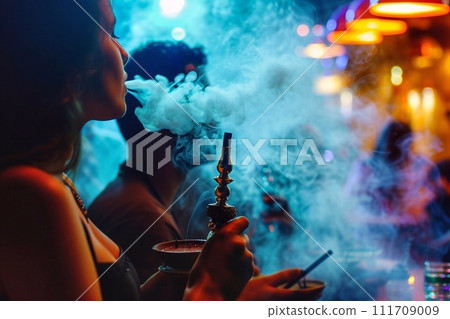 Girl with long hair smoke hookah in nightclub. Girl with long hair smoke hookah in nightclub. 111709009