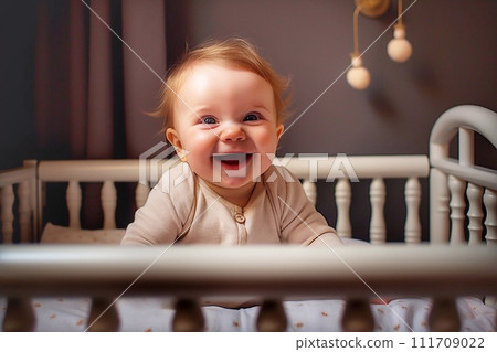 A cute little boy is sitting in a crib at home A cute little boy is sitting in a crib at home 111709022