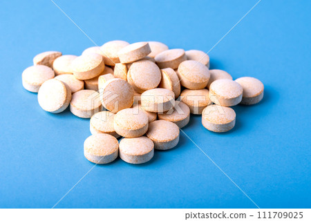 Orange pills vitamin C. pills on blue background. Orange pills vitamin C. pills on blue background. 111709025