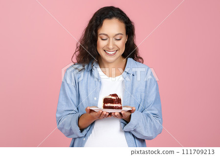 Happy young pregnant woman holding delicious cake 111709213