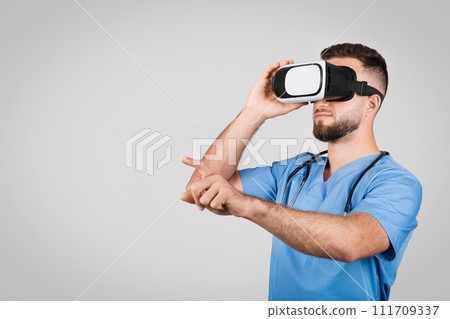 Male nurse in scrubs using VR headset for training Male nurse in scrubs using VR headset for training 111709337