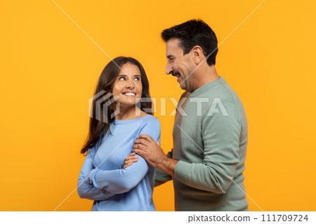 Two cheerful senior man and woman, share light-hearted moment, laughing and looking at each other Two cheerful senior man and woman, share light-hearted moment, laughing and looking at each other 111709724