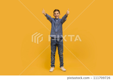 Cheerful Teen Boy Showing Thumbs Up At Camera With Two Hands 111709726