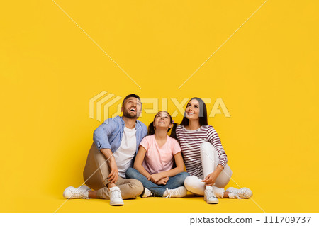 Nice Promo. Caucasian Family Of Three Sitting On The Floor, Looking Up 111709737