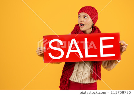 lady in red hat and scarf presenting poster sale, studio lady in red hat and scarf presenting poster sale, studio 111709750