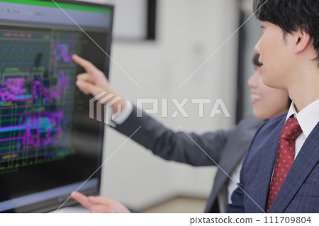 Men and women having a meeting looking at CAD drawings_4 111709804