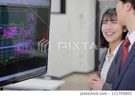 A man and a woman have a meeting looking at CAD drawings_5 111709805