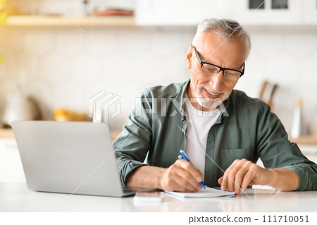 Online Learning For Older Adults. Senior Man Using Laptop And Taking Notes Online Learning For Older Adults. Senior Man Using Laptop And Taking Notes 111710051