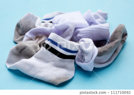 Dirty white socks on blue background. Dirty white socks on blue background. 111710092