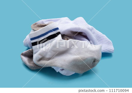 Dirty white socks on blue background. Dirty white socks on blue background. 111710094