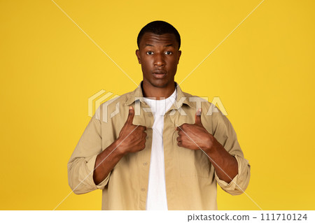 Shocked confused millennial black man in casual points fingers at himself, feels doubt, stress 111710124
