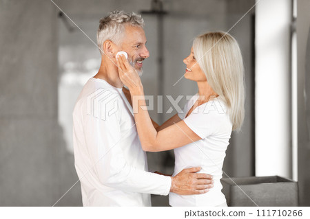 Portrait Of Happy Senior Couple Making Beauty Routine In Bathroom Together Portrait Of Happy Senior Couple Making Beauty Routine In Bathroom Together 111710266