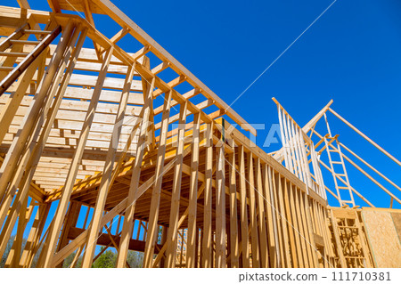 Timber wood stick frames framing beams during construction of new home 111710381