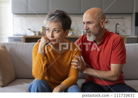 Caring Senior Husband Comforting His Upset Offended Wife At Home 111710631