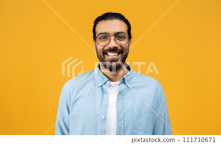 Indian cheerful millennial man with beard and glasses, wearing blue shirt Indian cheerful millennial man with beard and glasses, wearing blue shirt 111710671