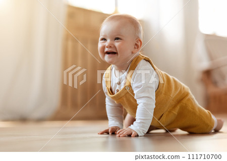 Cute little baby boy discovering world, crawling by home Cute little baby boy discovering world, crawling by home 111710700