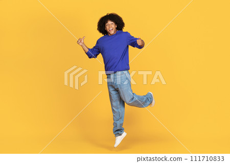 Joyful Young Black Man Jumping In Air And Showing Thumbs Up 111710833