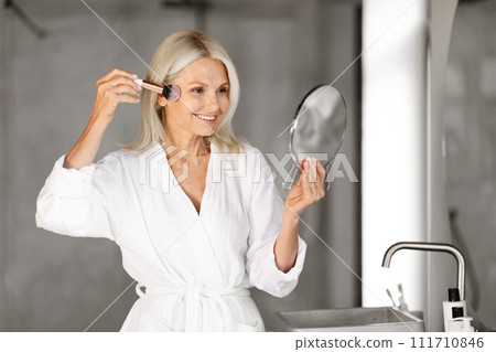 Daily Make Up. Portrait Of Beautiful Senior Woman Applying Blush In Bathroom 111710846