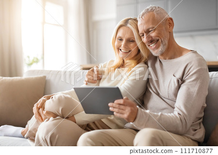 Happy Senior Couple Enjoying Digital Gadget World Using Their Tablet 111710877